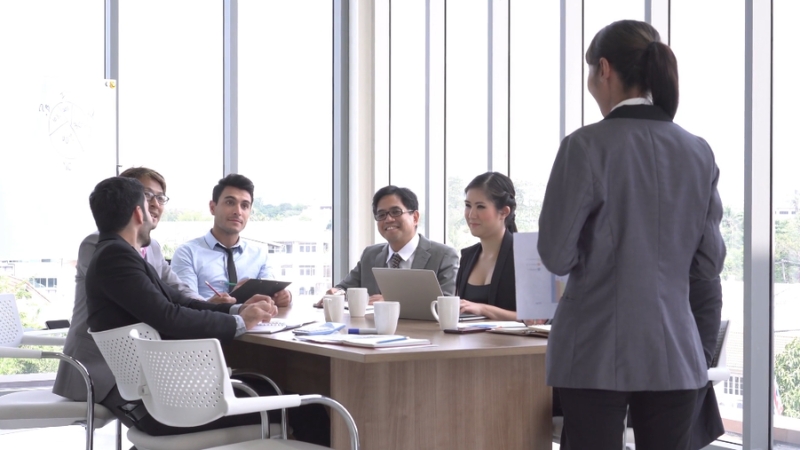 Image of a team meeting with a leader presenting to colleagues