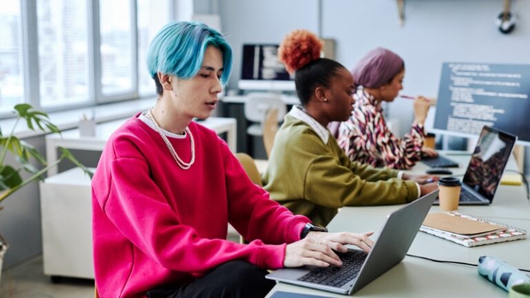 Gen Z employees working on laptops in a modern office space