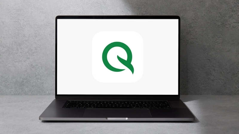 A laptop shows the Quire logo, featuring one of the top free productivity apps for structured project planning