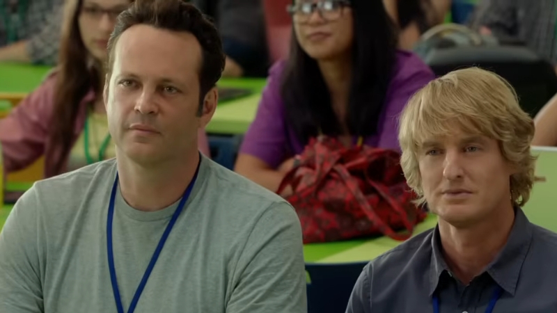 Two interns sit attentively in a training session at Google in a scene from The Internship
