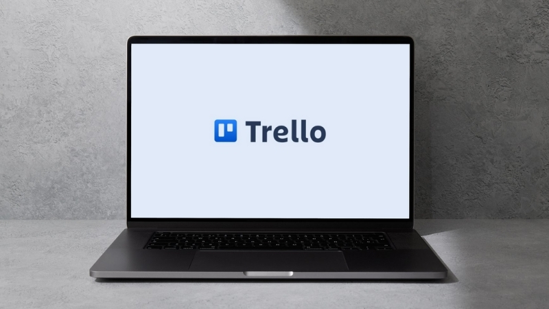 A laptop displays the Trello logo on screen, showing one of the top free productivity apps for visual project planning