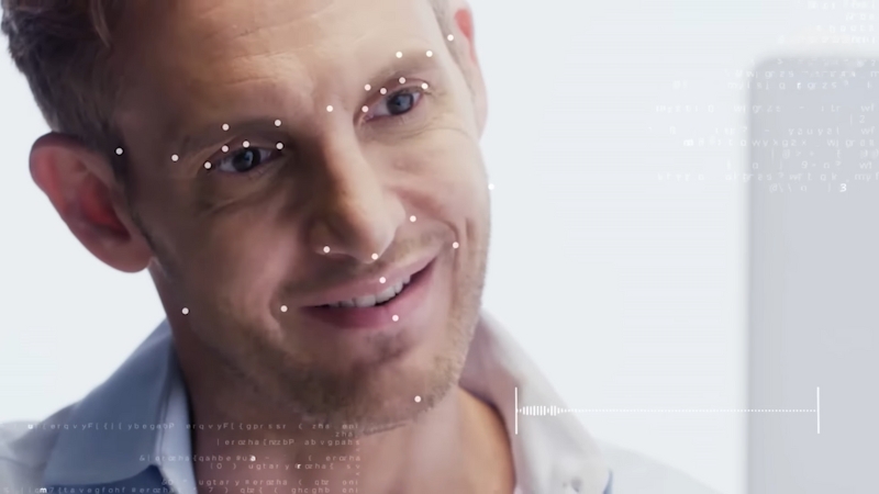Man looking at a screen with facial recognition points, symbolizing AI-driven HR software automation